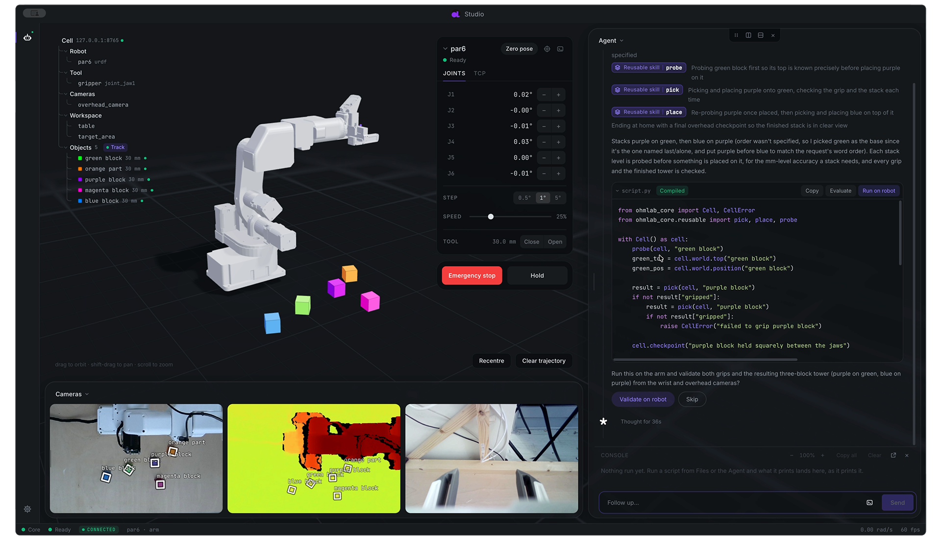Ohm Lab Studio: a simulated robot arm, joint controls and camera feeds beside the agent panel